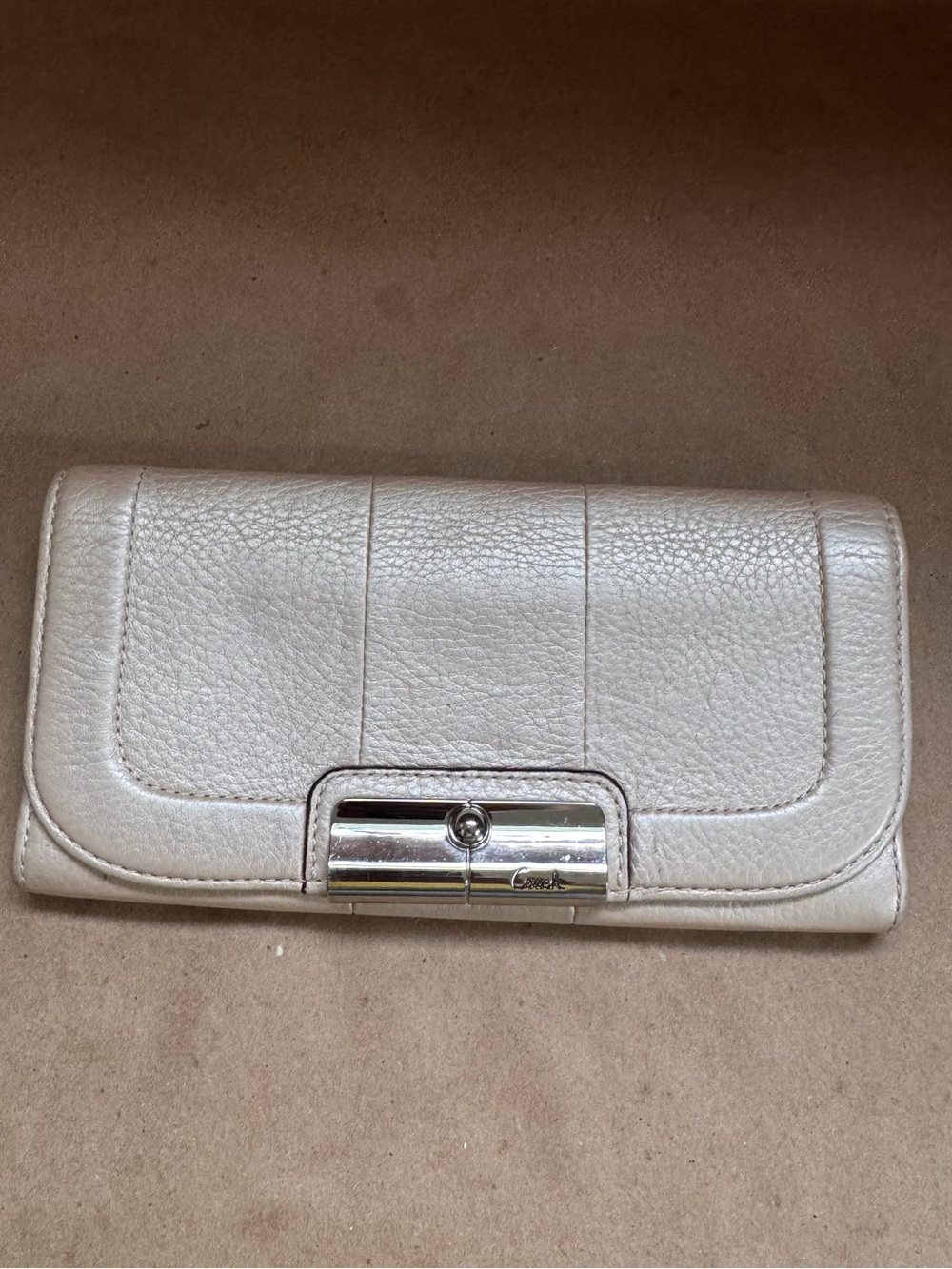 Coach Kristin Flap Wallet in Champagne Pebble Leather. 7.5” by 4” by 0.5”